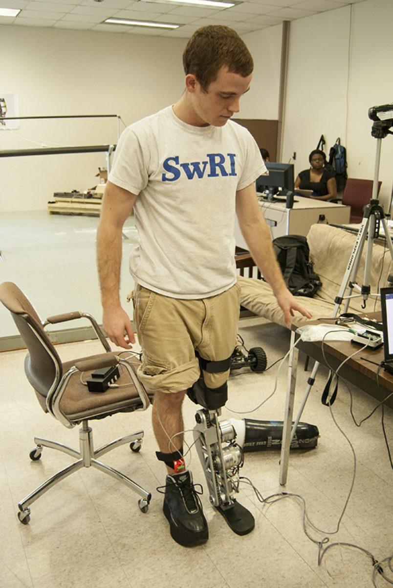 <p>Photo by Dee Huggan</p><p>A member of the AMBER Lab tries on a sophisticated prosthesis that reacts to a wearer's movements within milliseconds. </p>