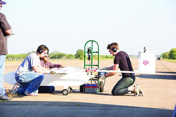 Photo by Cody Franklin 
Aerospace engineering graduate student Jim Henrickson (right) and fellow researchers prepare Pegasus II for take-off Saturday morning at Texas A&M’s Riverside Campus.
 