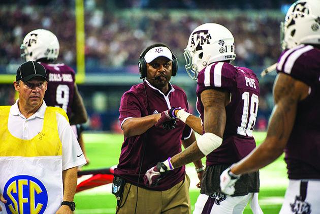 Tanner Garza — THE BATTALION
Head coach Kevin Sumlin fist-bumps wide receiver Edward Pope at the Arkansas game.  