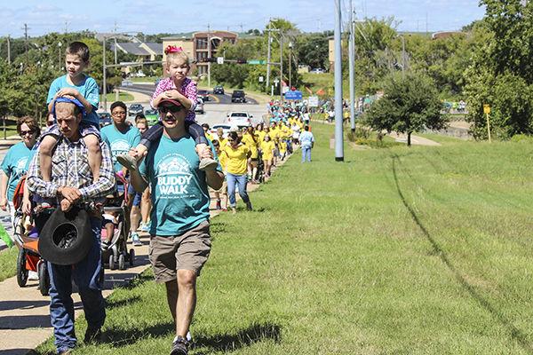 Families and friends gathered to support their loved ones to complete a one-mile walk.
Photo by Allison Bradshaw