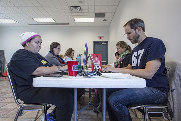Cody Franklin -- THE BATTALION
Ted Boone (right), lecturer in the Mays Business School, participates with NaNoWriMo members in a write-in at Larry J. Ringer Library in College Station Sunday afternoon.