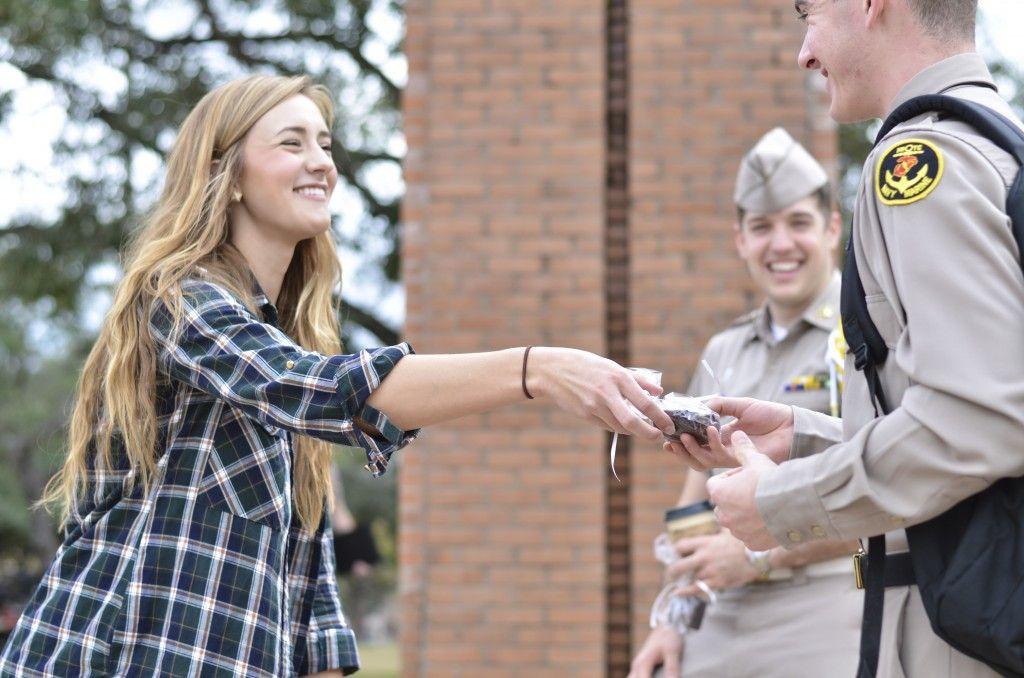 Business freshman Cassidy Lovett passes out free brownies to freshman cadets in the Quad Thursday.
Jonathan Sheen — The Battalion