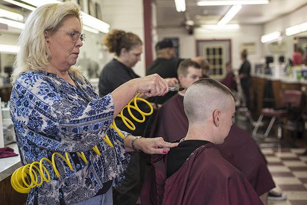 Photo By: Tanner Garza
Communication sophomore Wallis Harvey gets his hair trimmed by stylist Johanna Turner Monday afternoon at the Northgate Barbershop.