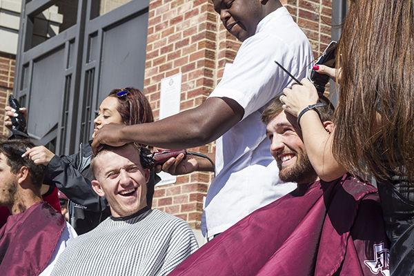 Players Cody Whiting and Jonathan Moroney get their heads shaved Saturday morning to support cancer patients.
Timothy Lai — THE BATTALION