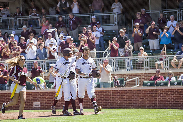 Michael Barash congratulates Logan Nottebrok after a home run at Sunday's game against Missouri.