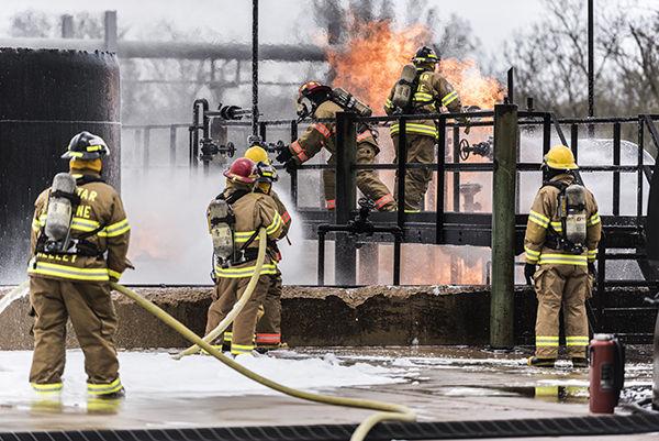 Tanner Garza — THE BATTALION
Firefighting students team up to put out fire  at the Texas  A&M Engineering Extension Service Brayton Fire Field spring training session Tuesday.
