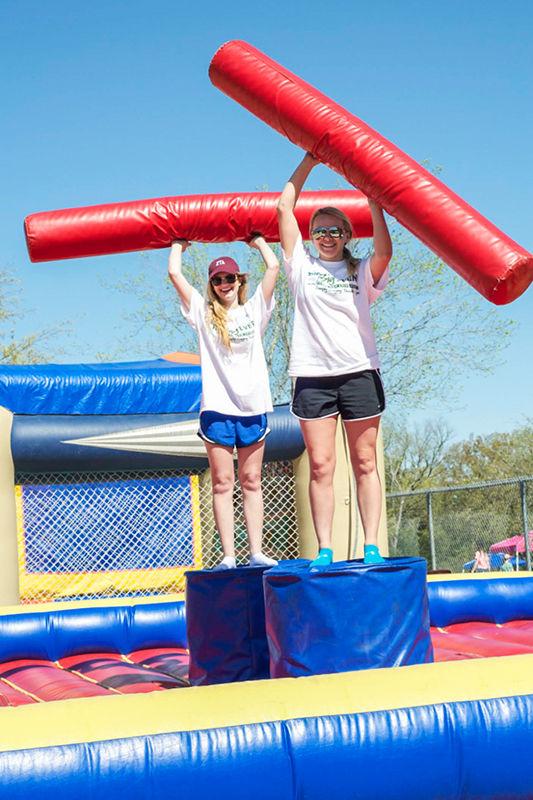 Communication junior Emily Balazik and Allied Health junior Katie Graham work at an inflatable knock-off competition.