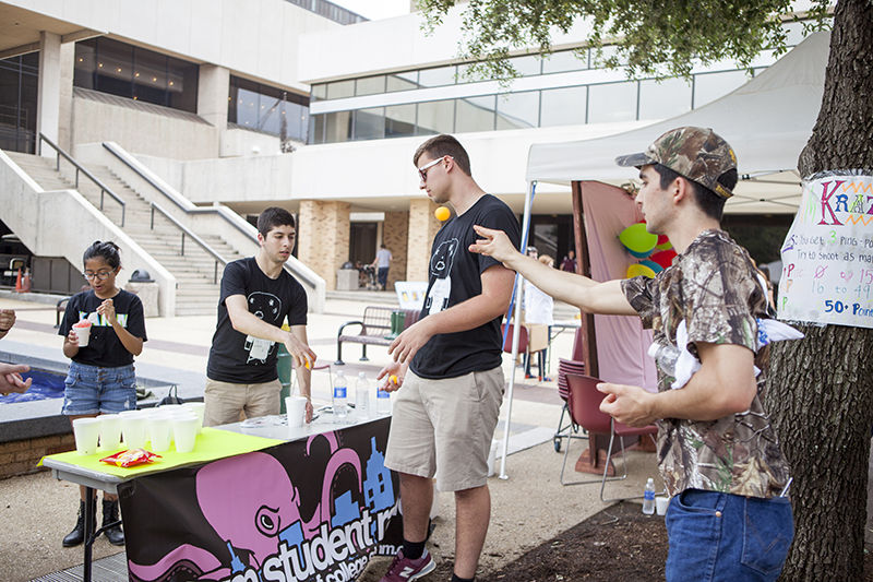 <p>Students shoot to win prizes at the KANM Student Radio table during the MSC Carnival Friday Afternoon</p>