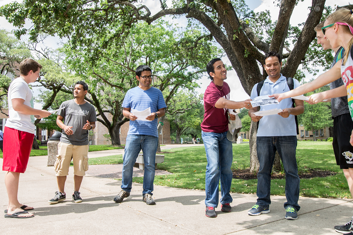 <p>Graduate students Rajan Thapa, Parveen Kumar Chhetri, Smit Dhakal and Manoj Rajaure (left to right) pass out flyers to raise awareness about the disaster in Nepal outside of the Memorial Student Center Monday afternoon.</p>