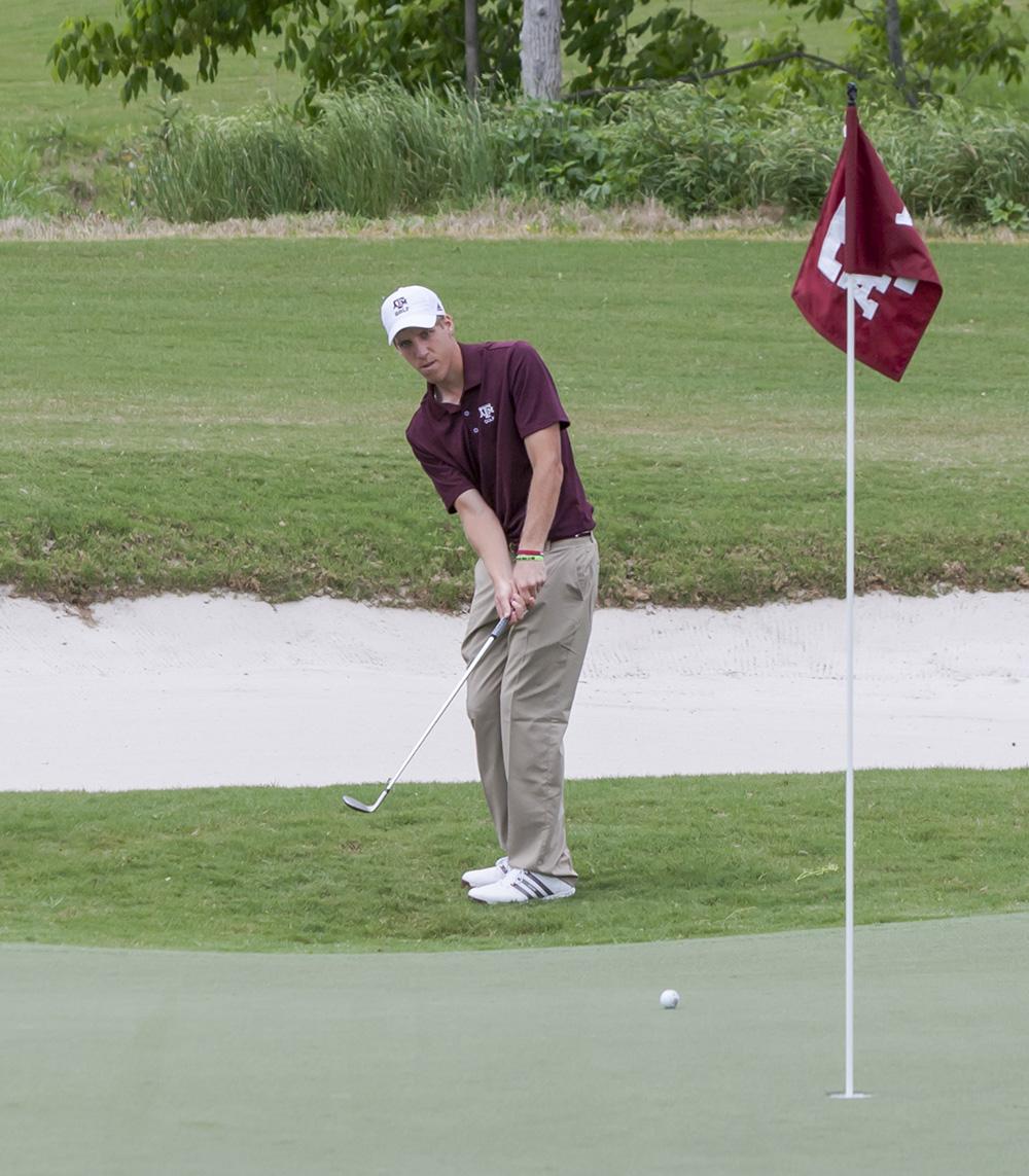 <p>Mickey Werenski chips the ball Saturday during the Aggie Invitational. </p>