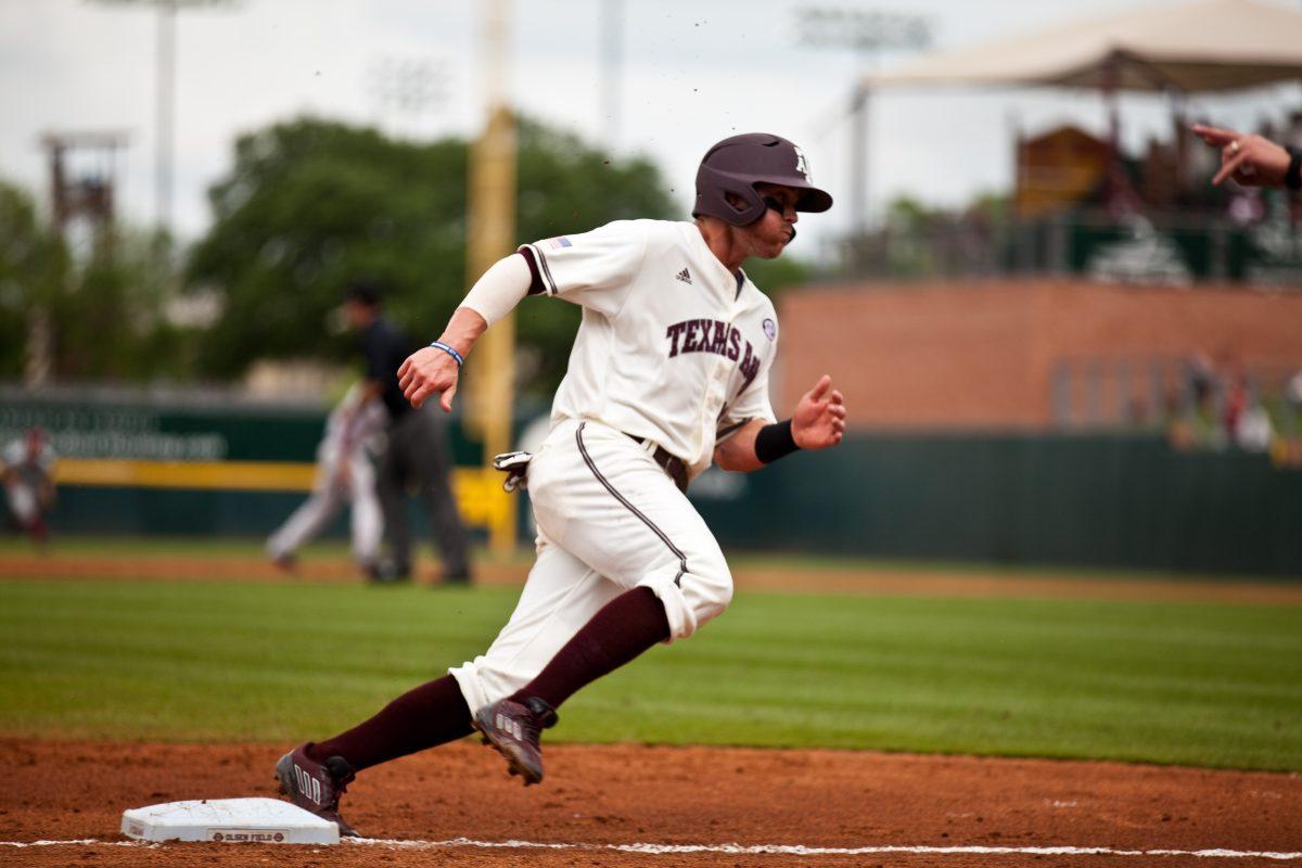 <p>Logan Taylor rounds third and heads home during Saturday's game .</p>