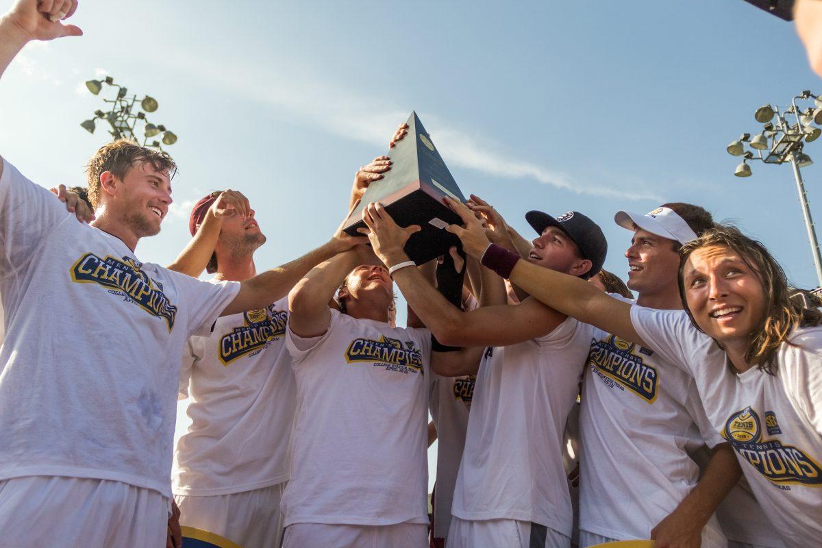 Mens tennis team celebrates after becoming SEC champions. 