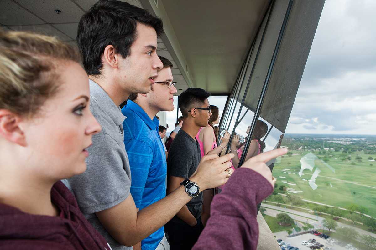 Meteorology juniors Lauren Replogle, Carlos Martinez, Dylan Smith and Edmar Ruano watch the funnel clouds form from the top floor of the Eller Oceanography and Meteorology Building Monday.