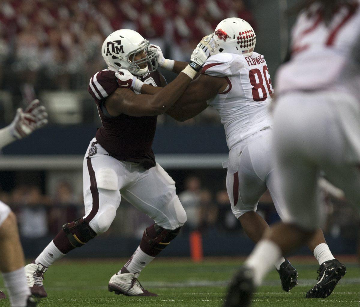 Texas A&M offensive tackle Cedric Ogbuehi battles Arkansas defensive end Trey Flowers at AT&T Stadium on Sept. 27, 2014. Ogbuehis selection in the first round of the 2015 NFL Draft by the Cincinnati Bengals gives the Aggies five straight years with at least one pick in the top round. 