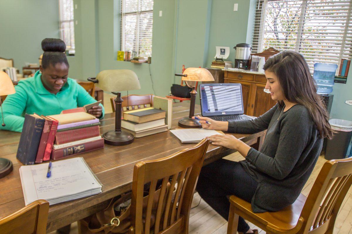 Tiffany Cousins, urban planning graduate student, and Hannah Shaw, recreation parks and tourism science senior, study in the downtown Bryan Reading Room. 