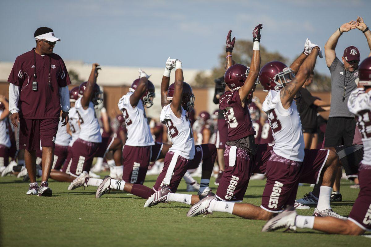 Coach+Sumlin+with+players+as+they+prepare+for+drills+on+the+first+day+of+Fall+camp
