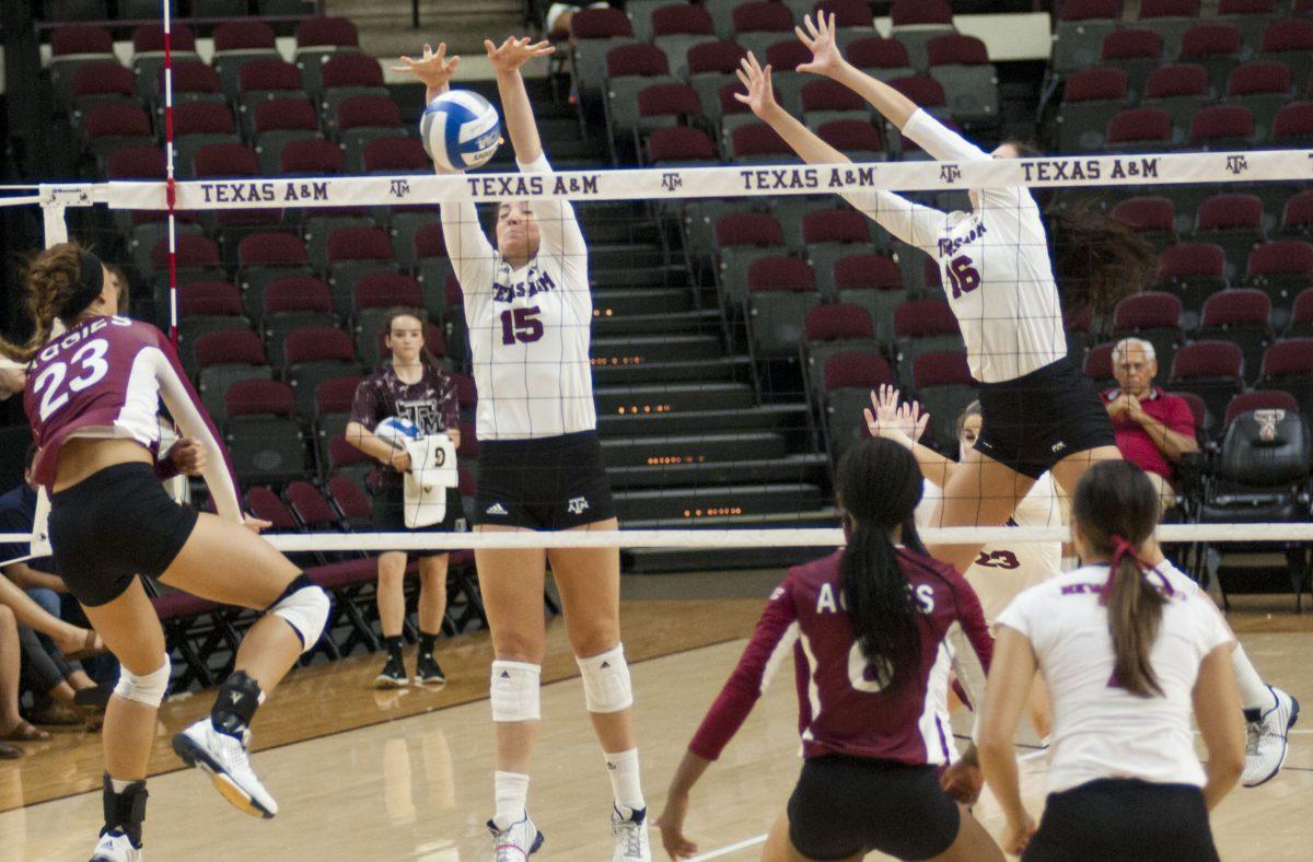 <p>Ashlie Reason blocks a spike against New Mexico State on Sunday, September 6th.</p>