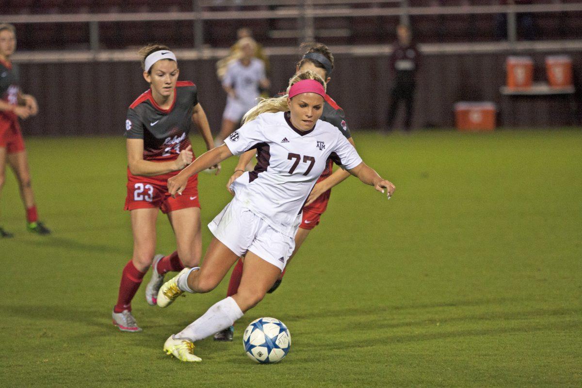 Mikaela Harvey dribbles the ball down the field with Ole Miss players close behind.&#160;