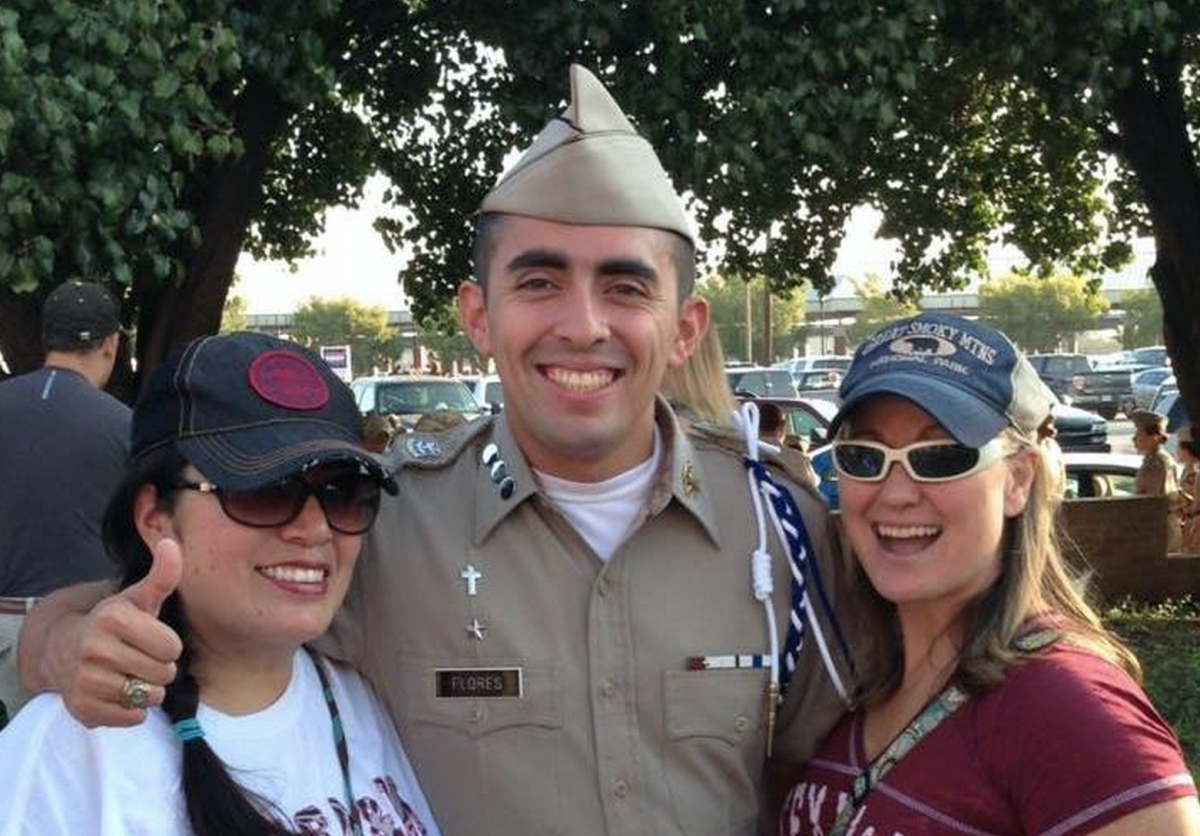 Evan Flores stands by his mother and her new wife on campus.