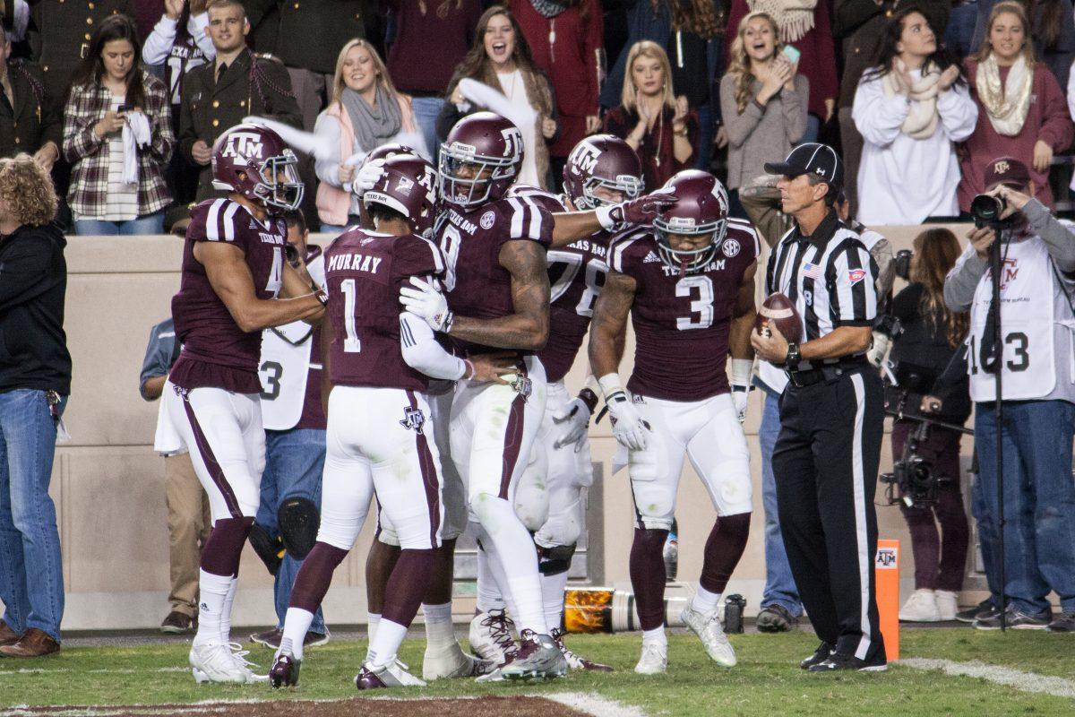 Aggie+teammates+celebrate+with+Christian+Kirk+following+his+touchdown+victory.