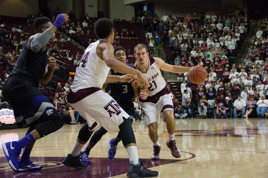 Senior Alex Caruso&#160;works his way around a Kansas State player to move the ball down to the court.&#160;