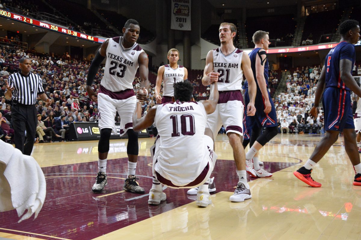 Center Tonny Trocha-Morelos is helped up by his teammates after getting fouled.