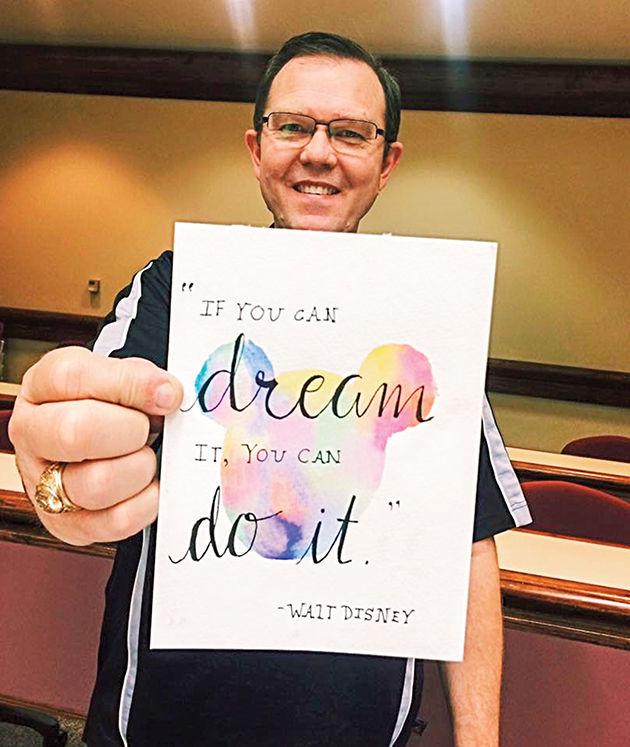 Rusty Thompson, director of Student Activities and Muster Committee advisor, died March 12 after suffering a heart attack a week prior. In the above photo, Thompson is holding a gift from a student that depicts a quote he has shared with Muster Committee at past first general meetings.