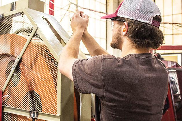 Mechanical engineering graduate student Jeff Brown works in the AER Lab, where researchers are developing a new engine design. &#160;