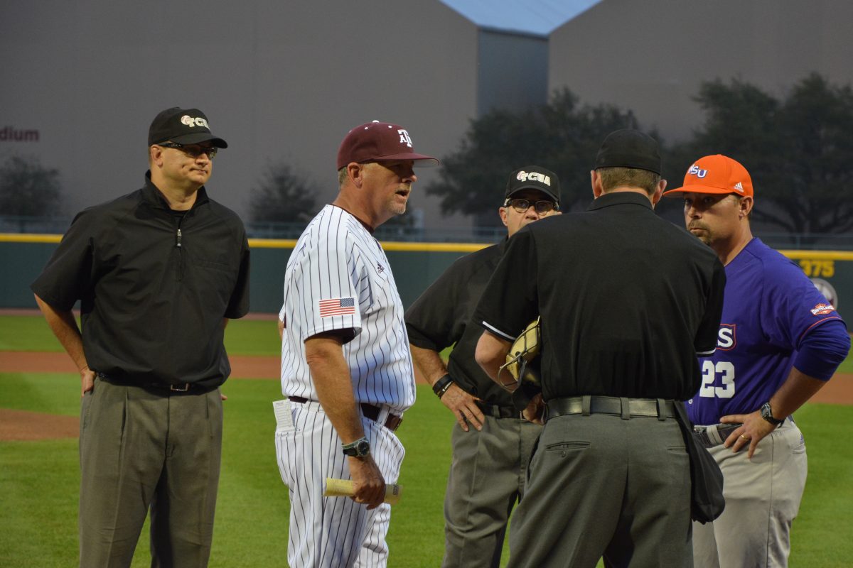 Head+Coach+Rob+Childress+talks+to+the+Umpire+and+Northwestern+State+coach+before+the+game.
