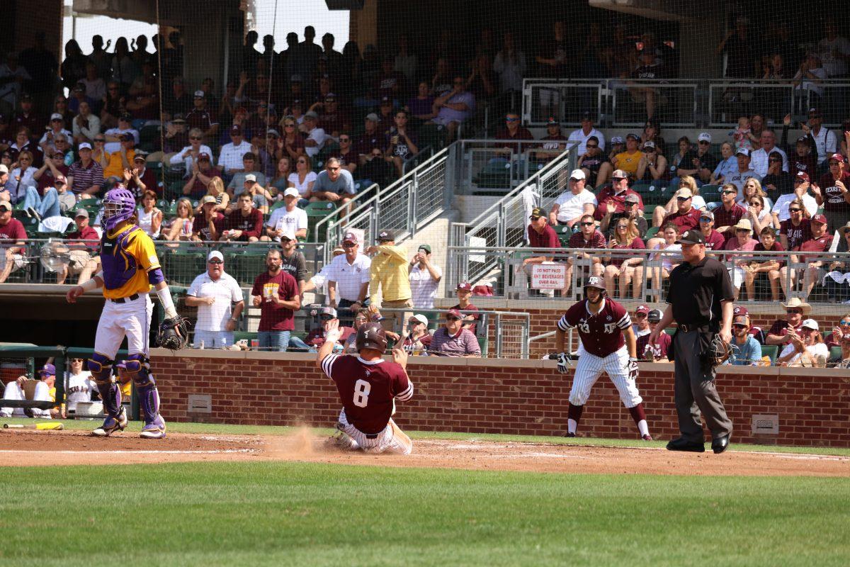 Senior Boomer White scores a run in Saturday's victory over LSU.