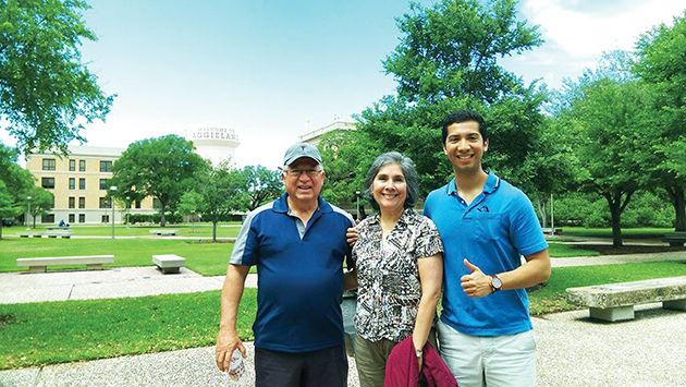 Aerospace engineering senior John Rangel walks his parents around campus before Muster.