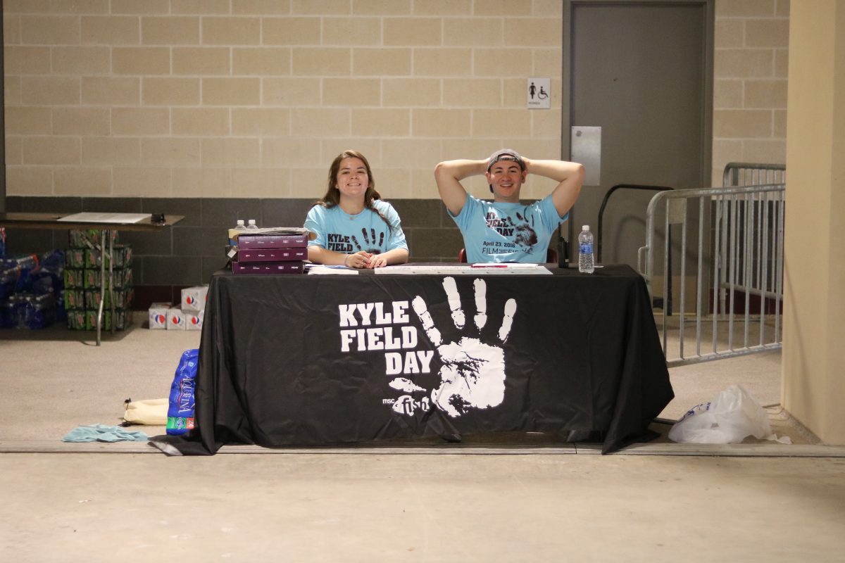 Freshman education major&#160;Clarissa Cupit&#160;and Freshman Business major&#160;Jordan Kacko&#160;eagerly wait for people to check in at Kyle Field Day.