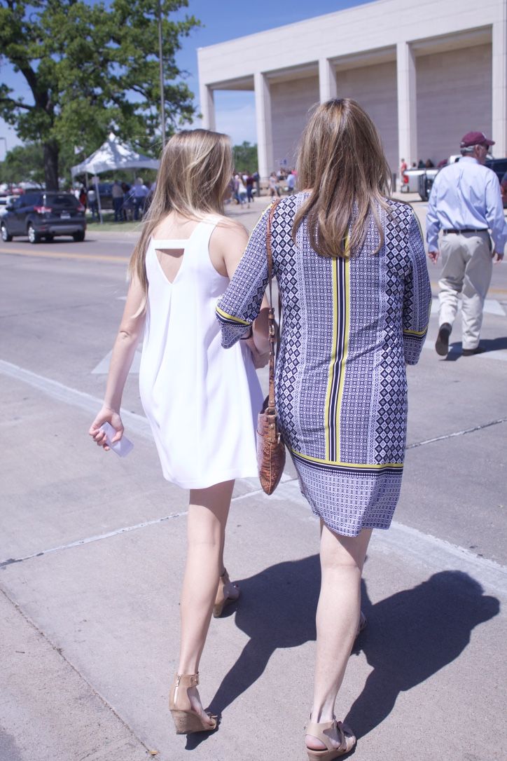 Student Caitlyn Moravits walking with her mother, Jeanna Moravits to the Association of Former Students to receive her hard earned Aggie ring.