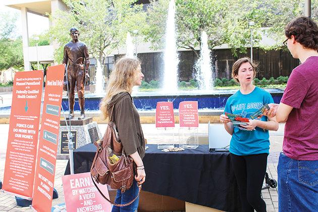 A+member+of+Pro-Life+Aggies+talks+to+passersby+in+Rudder+Plaza+Tuesday+about+the+benefits+Federally+Qualified+Health+Centers.