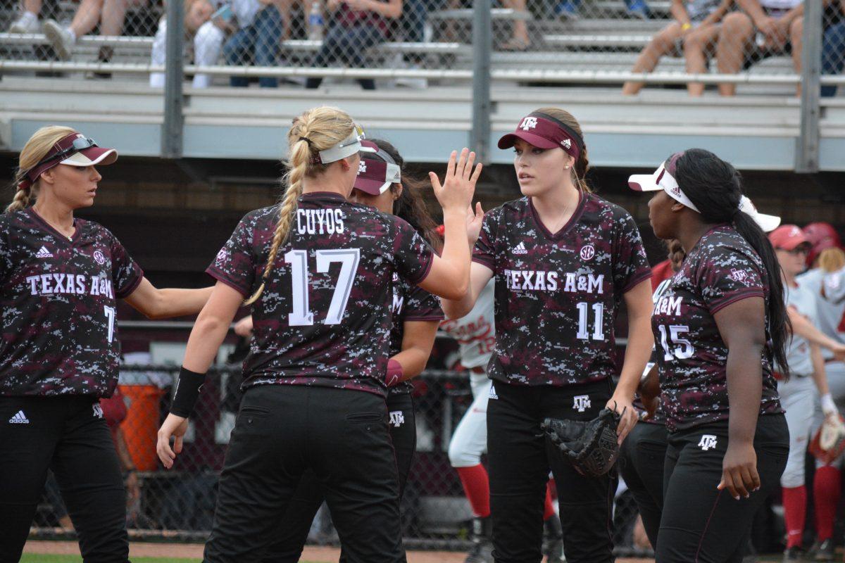 Sophomore&#160;Trinity Harrington&#160;high fives her teammates after striking out a batter and ending the inning.