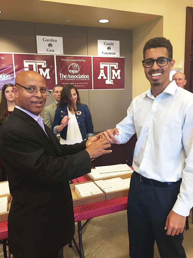Mickey Gashaw’s father, Gashaw Gebre, presents to Mickey his Aggie Ring on November 2015.