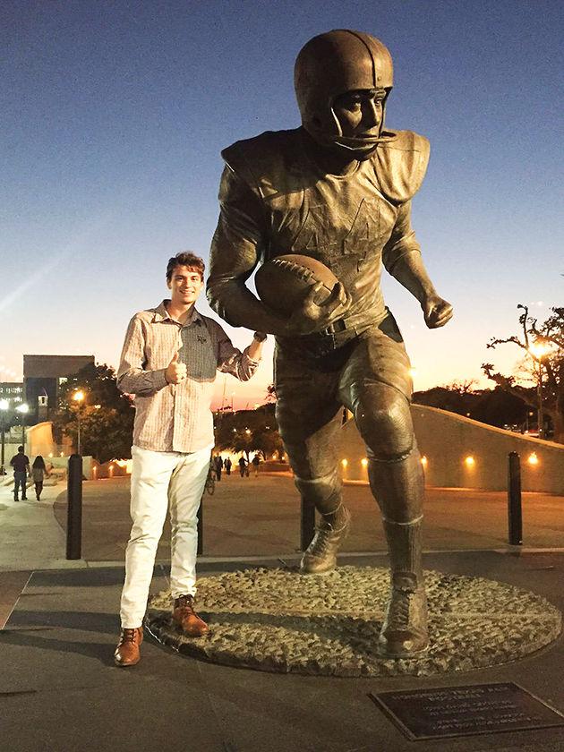 Jack Riewe, is the third Aggie in his family to receive a ring. He stands in front of John David Crow Statue on Ring Day last fall.