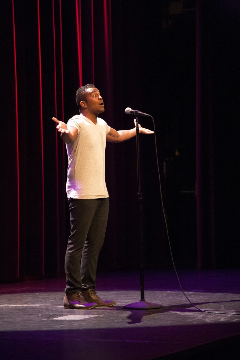 A poet spreads his arms and raises his voice during his performance at Texas Grand Slam.