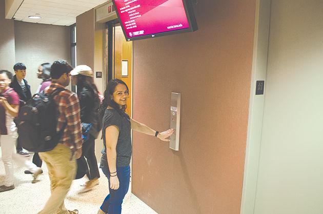 Graduate student Jaime Mitash uses an elevator in Rudder that allows people with disabilities to access upper floors.