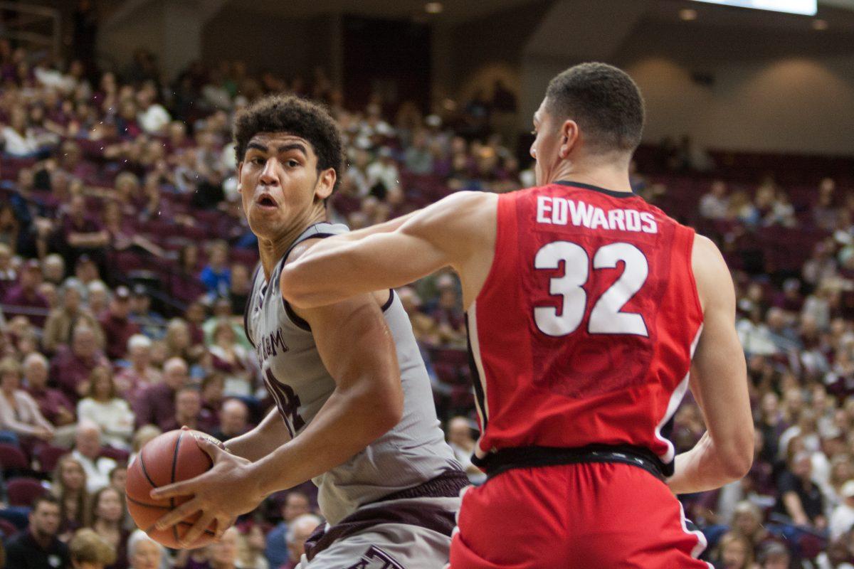 Sophomore Center&#160;Tyler Davis&#160;pivots around the defender in order to reach the basket.