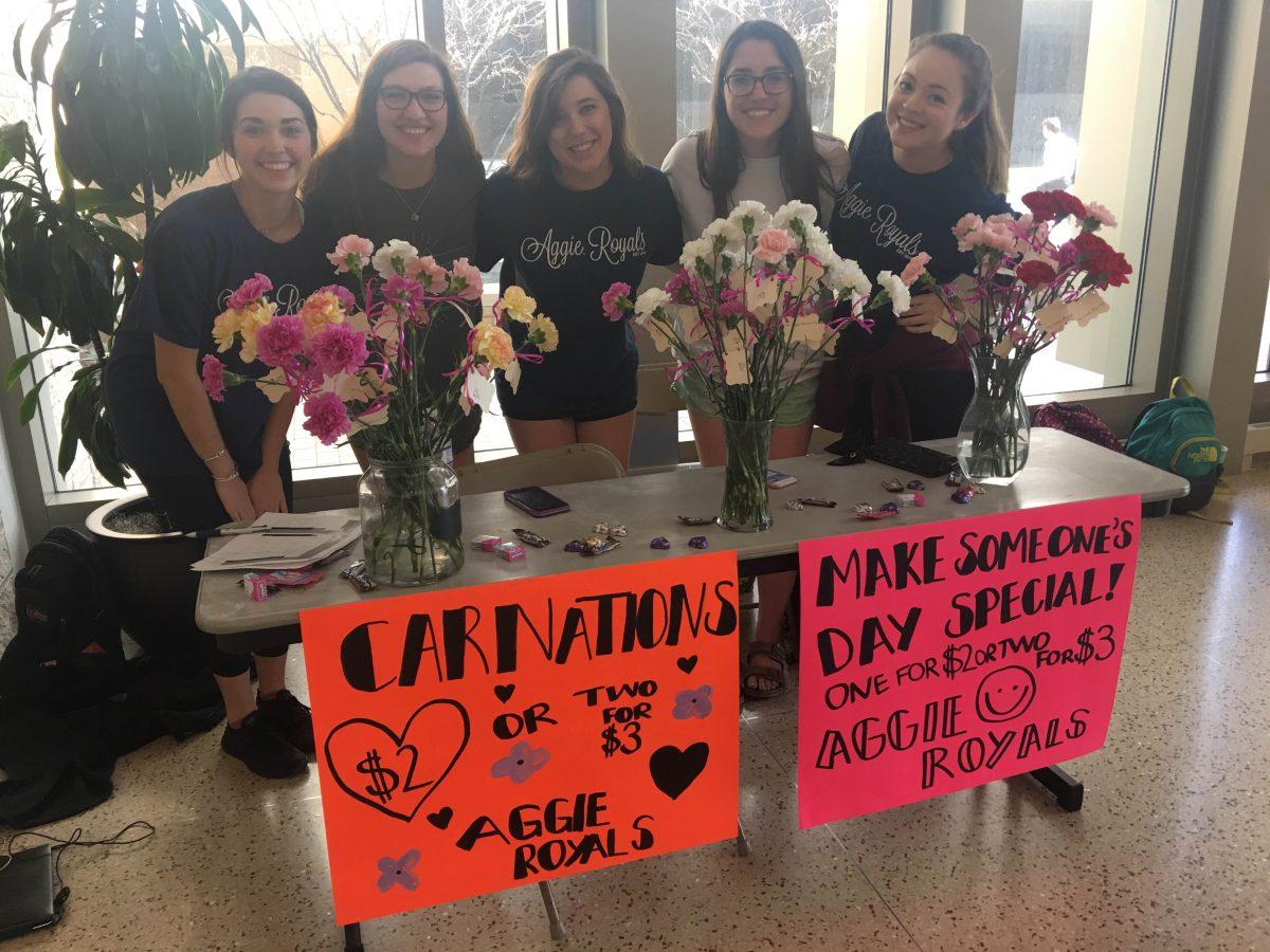 Members of Aggie Royals sell carnations for Valentines Day in the MSC 12th Man Hall. 