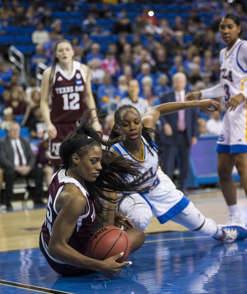 Texas A&Ms Anriel Howard dives to the floor to collect a loose ball.