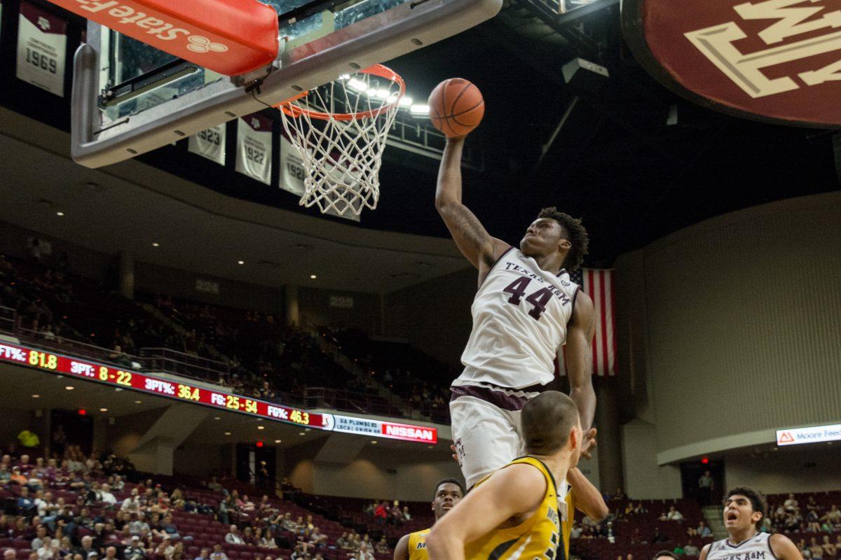 Freshman forward&#160;Robert Williams soars above the opposing team to dunk the ball.