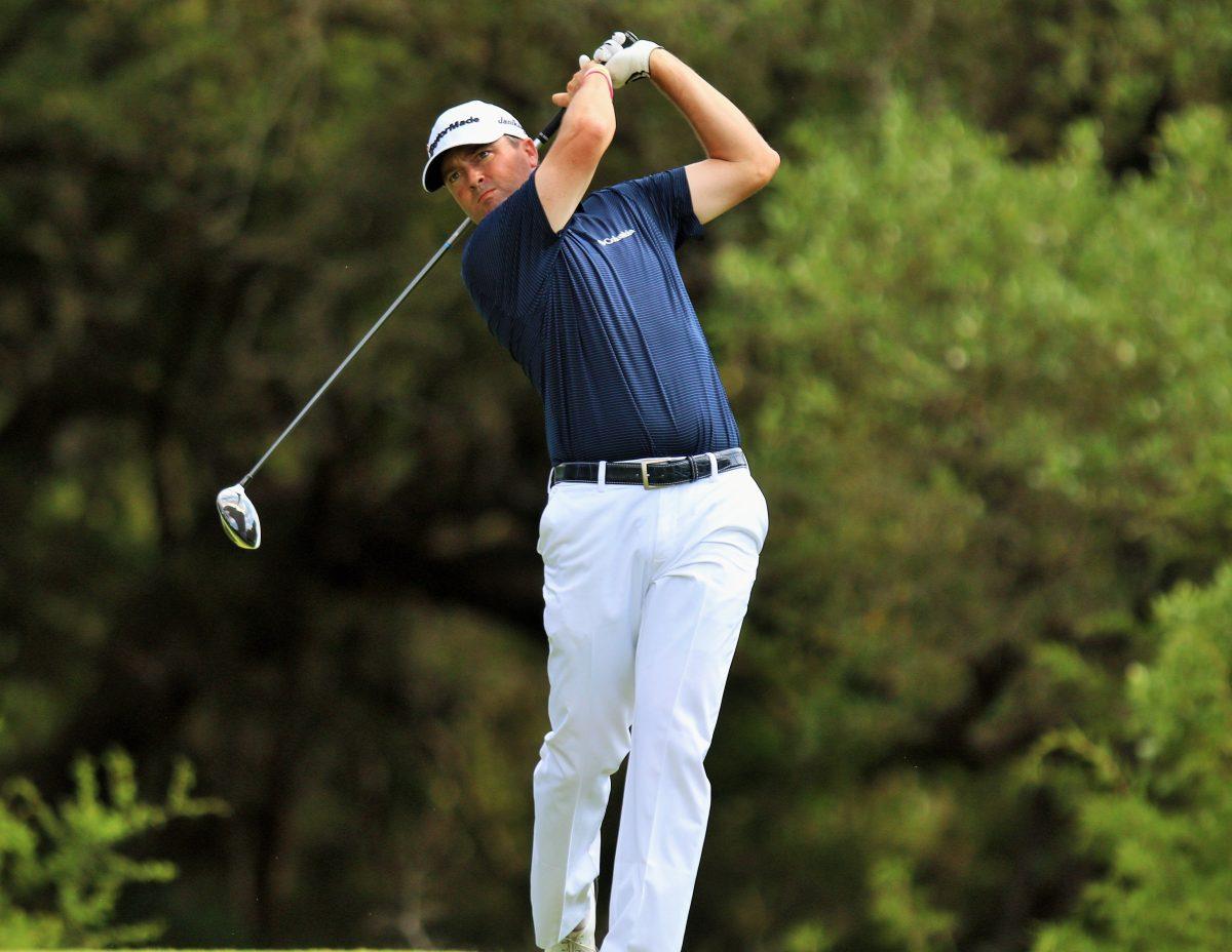 Palmer tees off on the 14th hole.