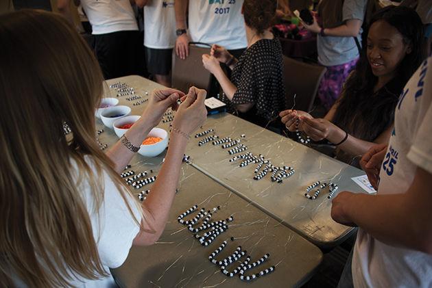 Communication junior&#160;Ashley Fitzhenry&#160;showed DNA Day visitors how to build DNA structures out of beads.