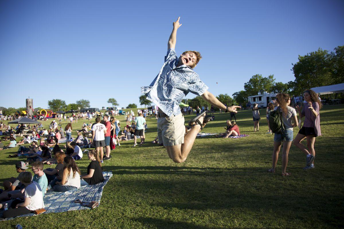 Sophomore manufacturing mechanical engineering technology major Erik Young joyfully leaps as the bands start to come on stage.