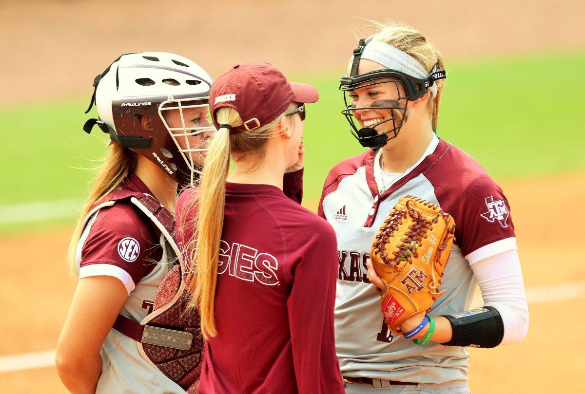 Show+smiles+while+talking+to+a+coach+and+the+catcher%2C+Ashley+Walters.