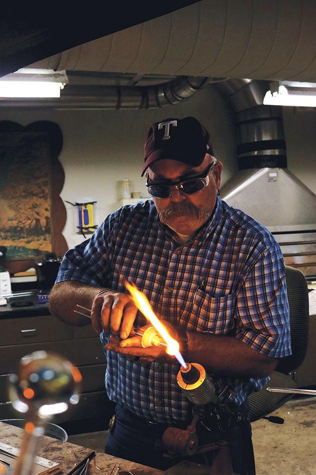 Bill Merka working at his on-campus glass shop. He has ran the shop for 33 years.