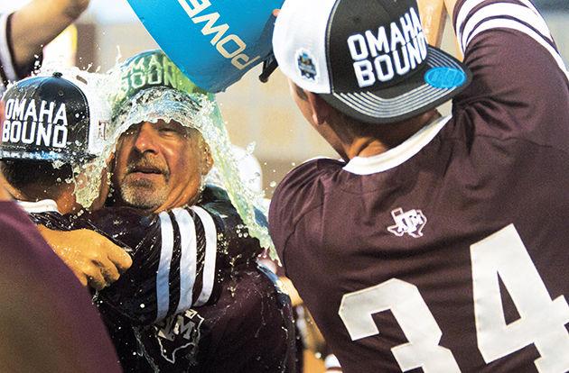 Mitchell Kilkenny dumps an ice bucket of Powerade on A&M head coach Rob Childress and Joel Davis in celebration of the Super Regional win.