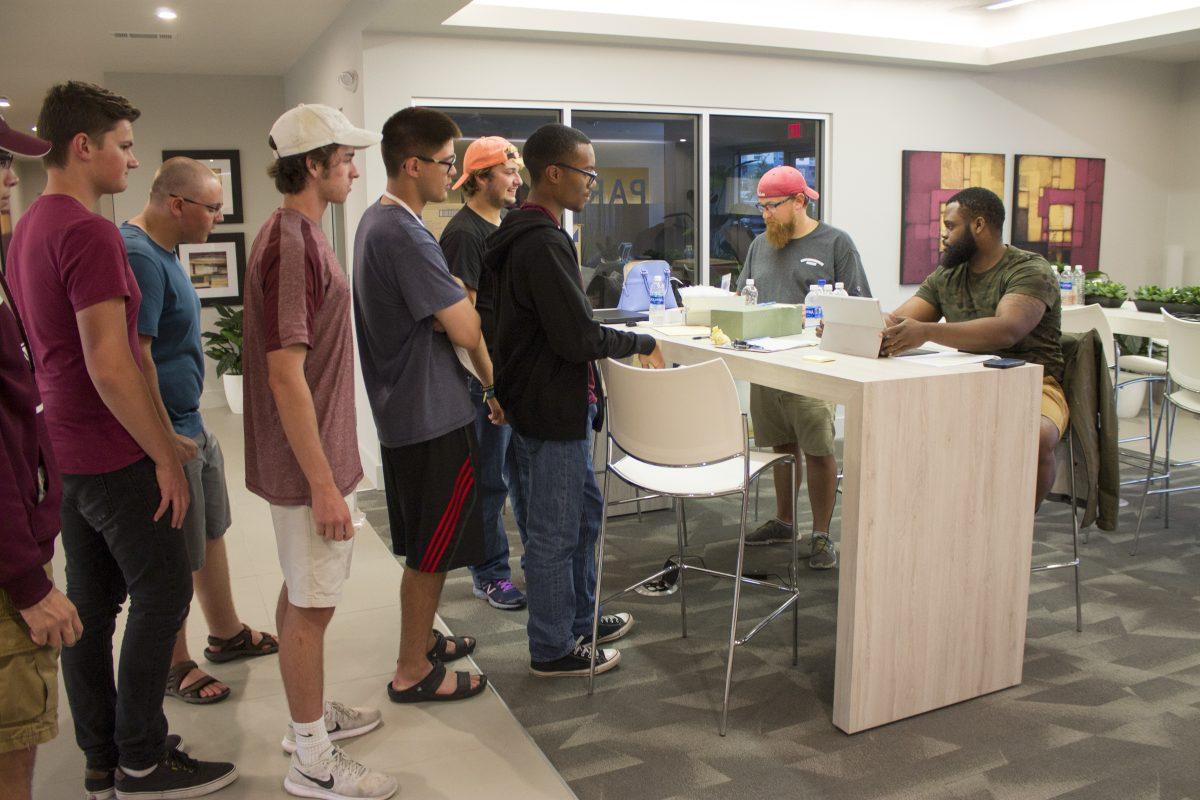 Texas A&amp;M Galveston students wait to receive assignments for the&#160;rooms at Park West they will call home until Hurricane Harvey passes.